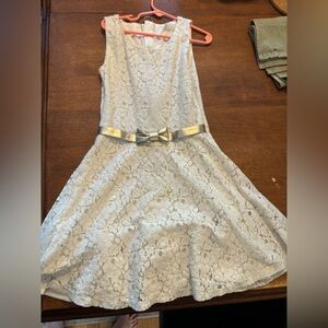 Cream colored dress with gold bow accent.